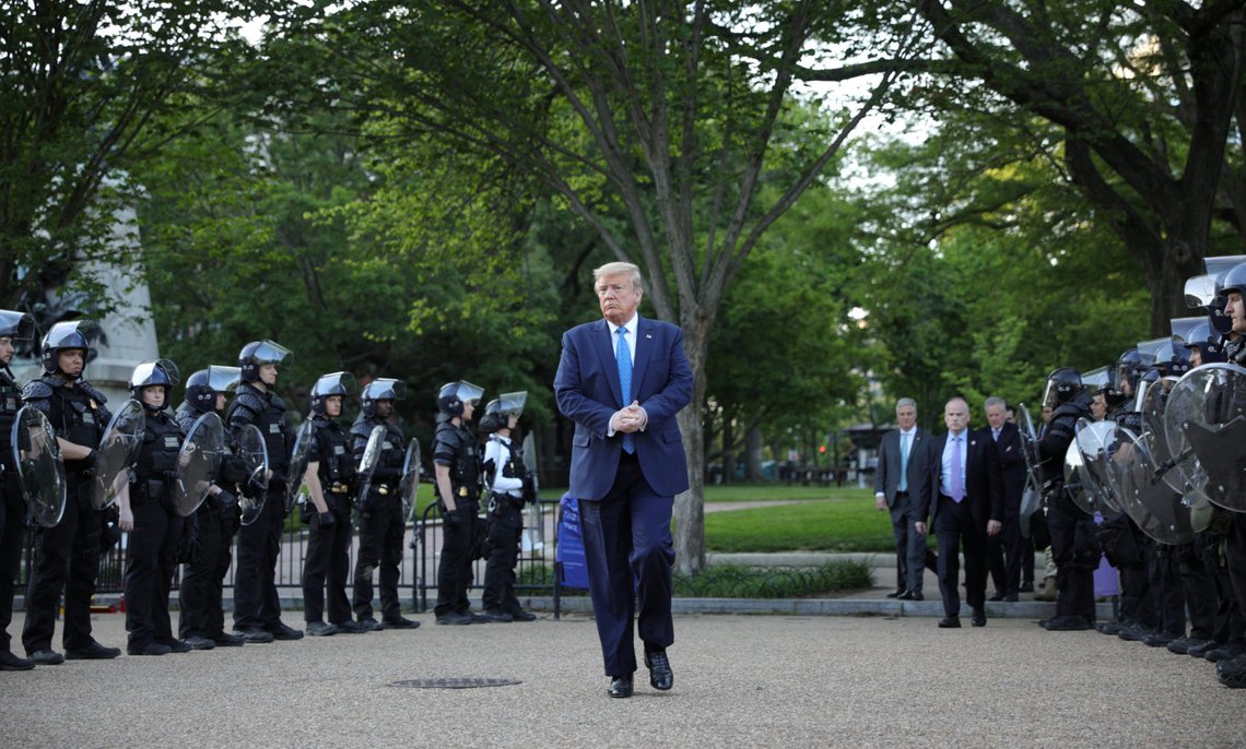 U.S. President Donald Trump walks between lines of riot police in Lafayette Park across from the White House after walking to St John's Church for a photo opportunity during ongoing protests over racial inequality in the wake of the death of George Floyd while in Minneapolis police custody, at the White House in Washington, U.S., June 1, 2020. REUTERS/Tom Brenner TPX IMAGES OF THE DAY U.S. President Donald Trump walks between lines of riot police in Lafayette Park across from the White House after walking to St John's Church for a photo opportunity during ongoing protests over racial inequality in the wake of the death of George Floyd while in Minneapolis police custody, at the White House in Washington, U.S., June 1, 2020. REUTERS/Tom Brenner TPX IMAGES OF THE DAY