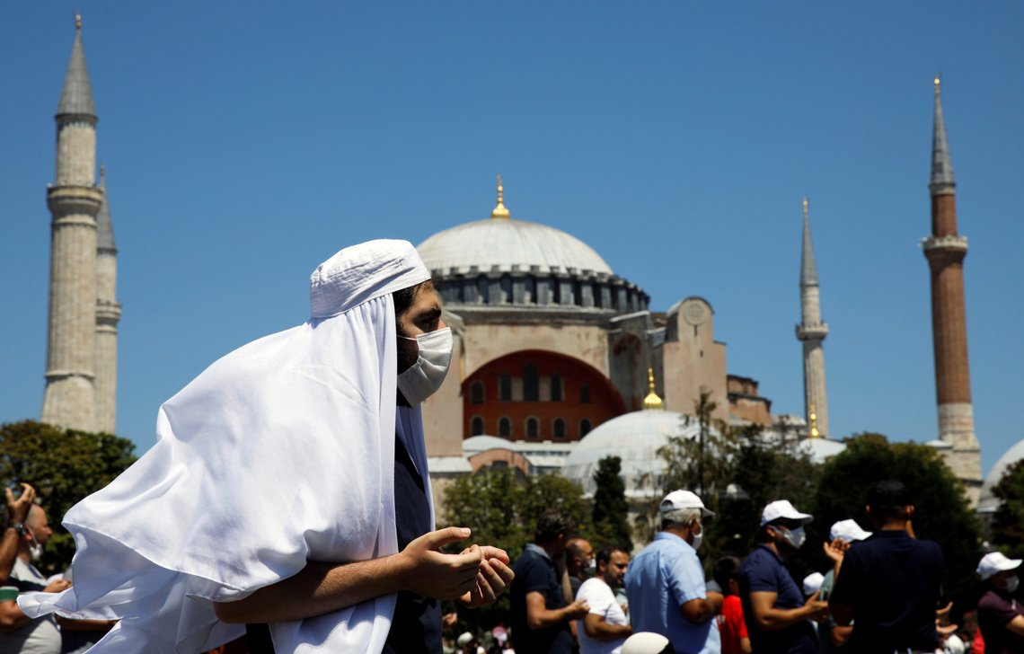 A man gestures as people wait for the beginning of Friday prayers outside Hagia Sophia Grand Mosque, for the first time after it was once again declared a mosque after 86 years, in Istanbul, Turkey, July 24, 2020. REUTERS/Umit Bektas A man gestures as people wait for the beginning of Friday prayers outside Hagia Sophia Grand Mosque, for the first time after it was once again declared a mosque after 86 years, in Istanbul, Turkey, July 24, 2020. REUTERS/Umit Bektas