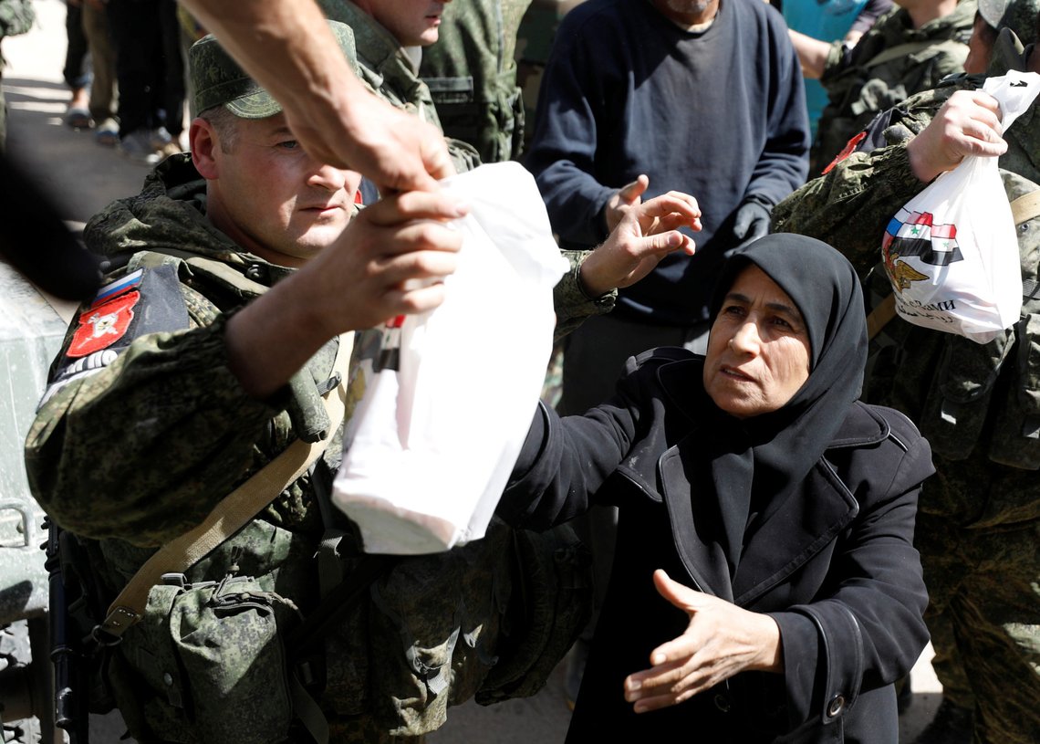 A woman who fled eastern Ghouta receives aid from Russian forces at a shelter in Adra, near Damascus, Syria, March 20, 2018. REUTERS/Omar Sanadiki A woman who fled eastern Ghouta receives aid from Russian forces at a shelter in Adra, near Damascus, Syria, March 20, 2018. REUTERS/Omar Sanadiki