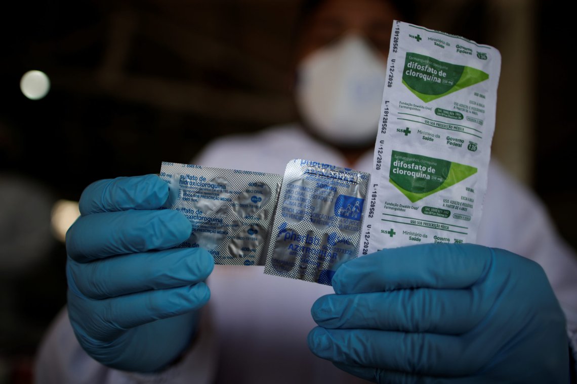 A healthcare worker holds a packet of hydroxychloroquine sulfate, azitrophar and chloroquine diphosphate, which some doctors have been distributing to people who have tested positive for COVID-19, as part of a remedy kit for treatment, at the riverside community Santo Ezequiel Moreno, as healthcare workers travel to riverside communities during the coronavirus disease (COVID-19) outbreak, in the municipality of Portel, at Marajo island, Para state, Brazil, June 5, 2020. REUTERS/Ueslei Marcelino SEARCH "COVID-19 BRAZIL AMAZON" FOR THIS STORY. SEARCH "WIDER IMAGE" FOR ALL STORIES A healthcare worker holds a packet of hydroxychloroquine sulfate, azitrophar and chloroquine diphosphate, which some doctors have been distributing to people who have tested positive for COVID-19, as part of a remedy kit for treatment, at the riverside community Santo Ezequiel Moreno, as healthcare workers travel to riverside communities during the coronavirus disease (COVID-19) outbreak, in the municipality of Portel, at Marajo island, Para state, Brazil, June 5, 2020. REUTERS/Ueslei Marcelino SEARCH "COVID-19 BRAZIL AMAZON" FOR THIS STORY. SEARCH "WIDER IMAGE" FOR ALL STORIES