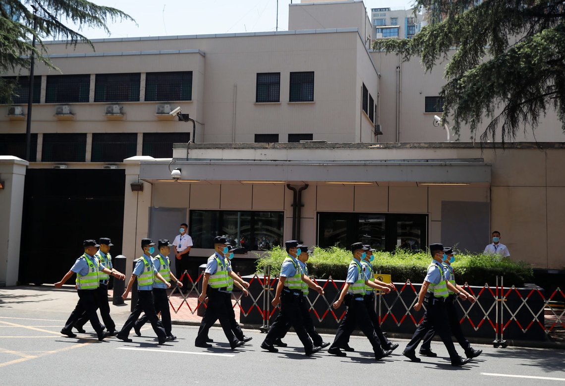 Police march in front of the former U.S. Consulate General in Chengdu, Sichuan province, China, July 27, 2020, after China ordered its closure in response to U.S. order for China to shut its consulate in Houston. REUTERS/Thomas Peter Police march in front of the former U.S. Consulate General in Chengdu, Sichuan province, China, July 27, 2020, after China ordered its closure in response to U.S. order for China to shut its consulate in Houston. REUTERS/Thomas Peter