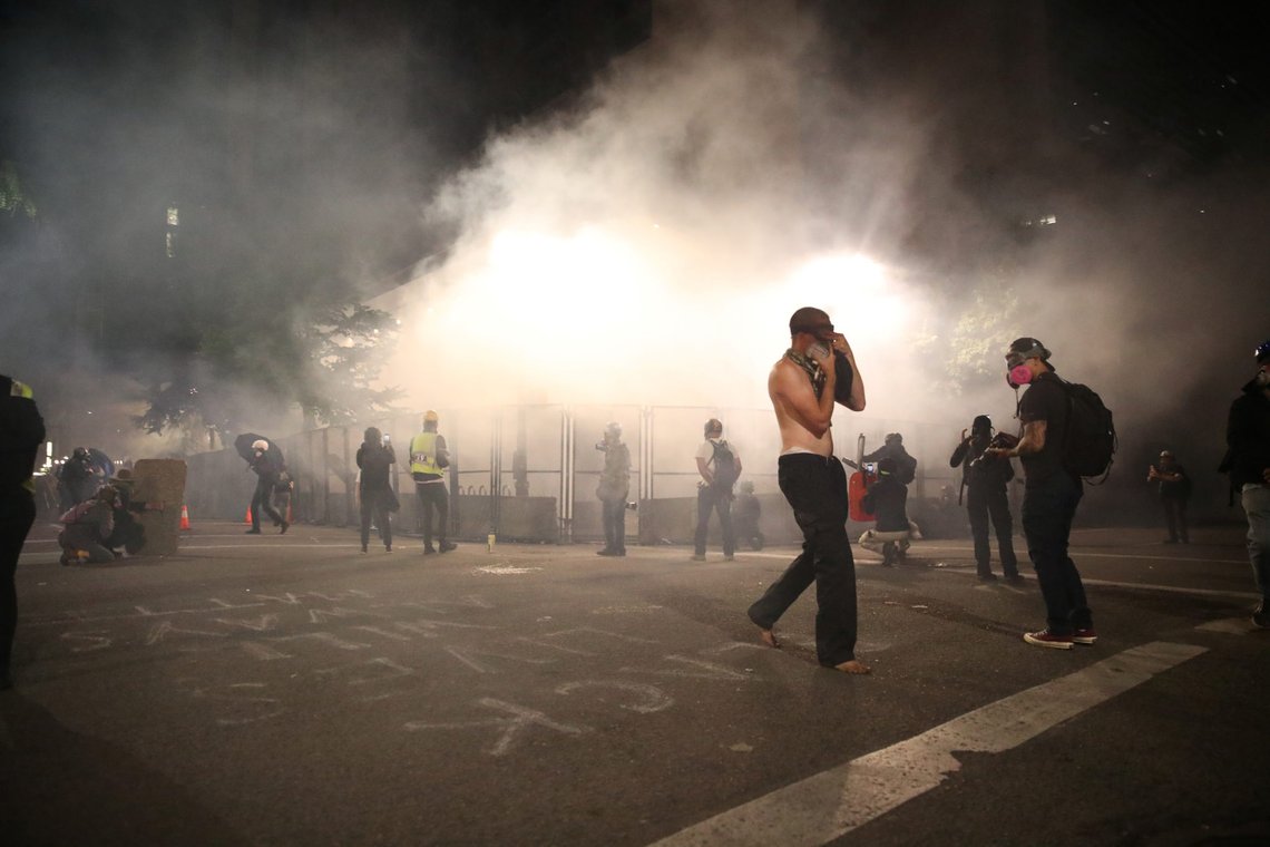 Protesters move away from tear gas shot by federal law enforcement officers during a demonstration against police violence and racial inequality in Portland, Oregon, U.S., July 27, 2020. REUTERS/Caitlin Ochs Protesters move away from tear gas shot by federal law enforcement officers during a demonstration against police violence and racial inequality in Portland, Oregon, U.S., July 27, 2020. REUTERS/Caitlin Ochs