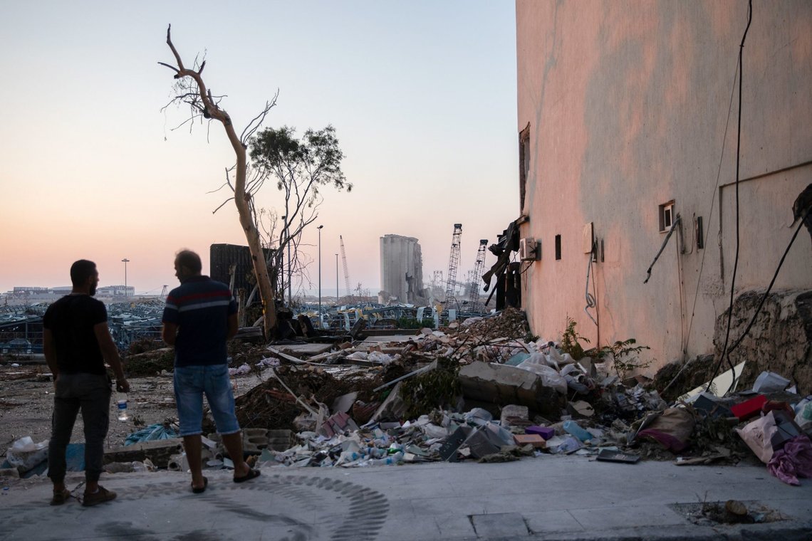 People look at the damaged port area following a massive explosion, in Beirut, Lebanon, August 14, 2020. REUTERS/Alkis Konstantinidis People look at the damaged port area following a massive explosion, in Beirut, Lebanon, August 14, 2020. REUTERS/Alkis Konstantinidis