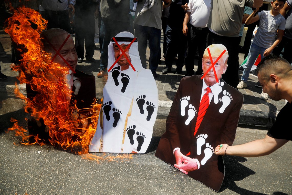 Palestinians burn cutouts depicting U.S. President Donald Trump and Abu Dhabi Crown Prince Mohammed bin Zayed al-Nahyan and Israeli Prime Minister Benjamin Netanyahu during a protest against the United Arab Emirates' deal with Israel to normalise relations, in Nablus in the Israeli-occupied West Bank August 14, 2020. REUTERS/Raneen Sawafta Palestinians burn cutouts depicting U.S. President Donald Trump and Abu Dhabi Crown Prince Mohammed bin Zayed al-Nahyan and Israeli Prime Minister Benjamin Netanyahu during a protest against the United Arab Emirates' deal with Israel to normalise relations, in Nablus in the Israeli-occupied West Bank August 14, 2020. REUTERS/Raneen Sawafta