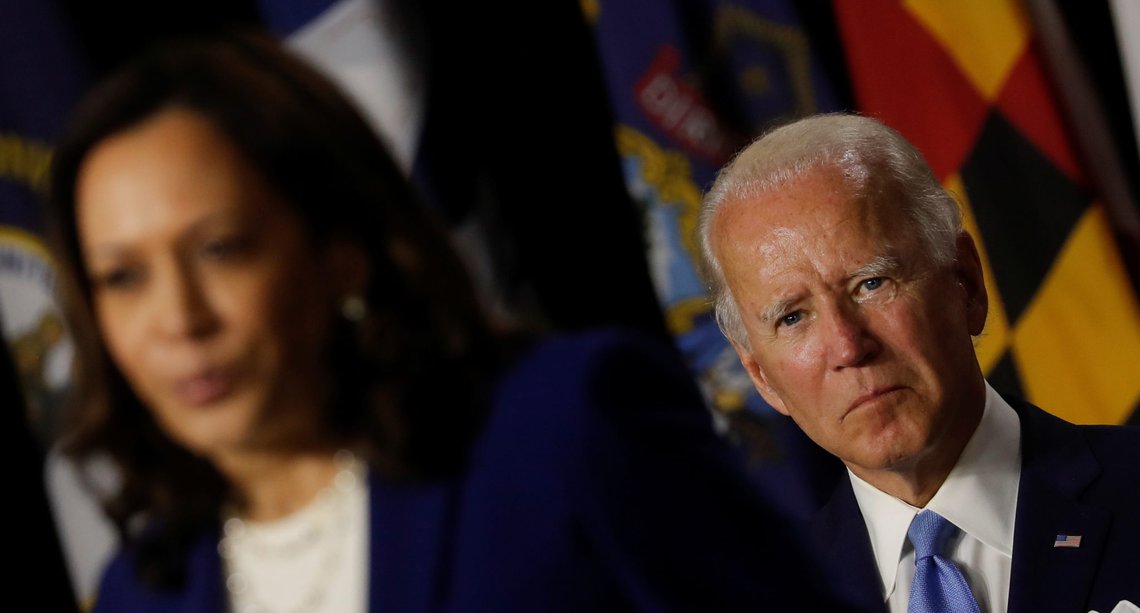 Democratic presidential candidate and former Vice President Joe Biden listens as vice presidential candidate Senator Kamala Harris speaks at a campaign event, their first joint appearance since Biden named Harris as his running mate, at Alexis Dupont High School in Wilmington, Delaware, U.S., August 12, 2020. REUTERS/Carlos Barria Democratic presidential candidate and former Vice President Joe Biden listens as vice presidential candidate Senator Kamala Harris speaks at a campaign event, their first joint appearance since Biden named Harris as his running mate, at Alexis Dupont High School in Wilmington, Delaware, U.S., August 12, 2020. REUTERS/Carlos Barria
