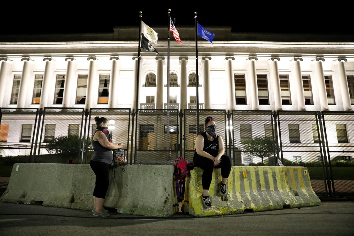 Women rest at a barricade in front of the Kenosha County Courthouse following the police shooting of Jacob Blake, a Black man, in Kenosha, Wisconsin, U.S. August 26, 2020. REUTERS/Brendan McDermid Women rest at a barricade in front of the Kenosha County Courthouse following the police shooting of Jacob Blake, a Black man, in Kenosha, Wisconsin, U.S. August 26, 2020. REUTERS/Brendan McDermid