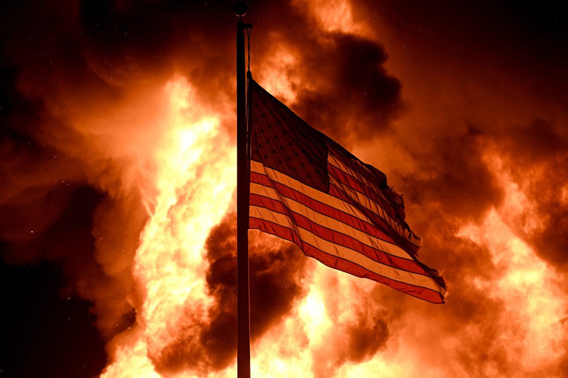 Flames engulf the Community Corrections Division building as an American flag flutters on a pole as protests turn to fires after a Black man, identified as Jacob Blake, was shot several times by police last night in Kenosha, Wisconsin, U.S. August 24, 2020. Picture taken August 24, 2020. REUTERS/Stephen Maturen TPX IMAGES OF THE DAY Flames engulf the Community Corrections Division building as an American flag flutters on a pole as protests turn to fires after a Black man, identified as Jacob Blake, was shot several times by police last night in Kenosha, Wisconsin, U.S. August 24, 2020. Picture taken August 24, 2020. REUTERS/Stephen Maturen TPX IMAGES OF THE DAY