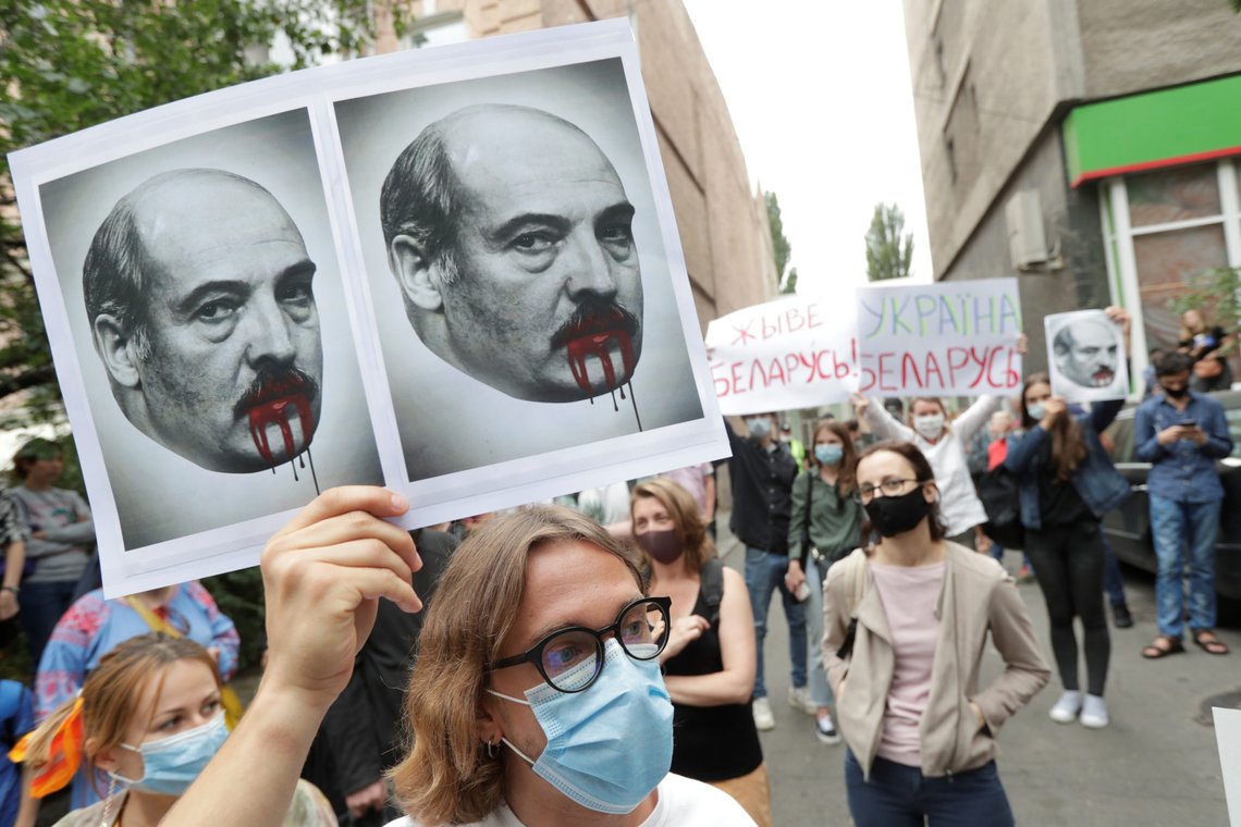 People attend a rally to support Belarusian opposition and demand from the authorities of Belarus to release Ukrainian citizens, who were detained during recent protests against the presidential election results, in Kyiv, Ukraine August 13, 2020. A participant holds a placard with images depicting Belarusian President Alexander Lukashenko. REUTERS/Valentyn Ogirenko People attend a rally to support Belarusian opposition and demand from the authorities of Belarus to release Ukrainian citizens, who were detained during recent protests against the presidential election results, in Kyiv, Ukraine August 13, 2020. A participant holds a placard with images depicting Belarusian President Alexander Lukashenko. REUTERS/Valentyn Ogirenko