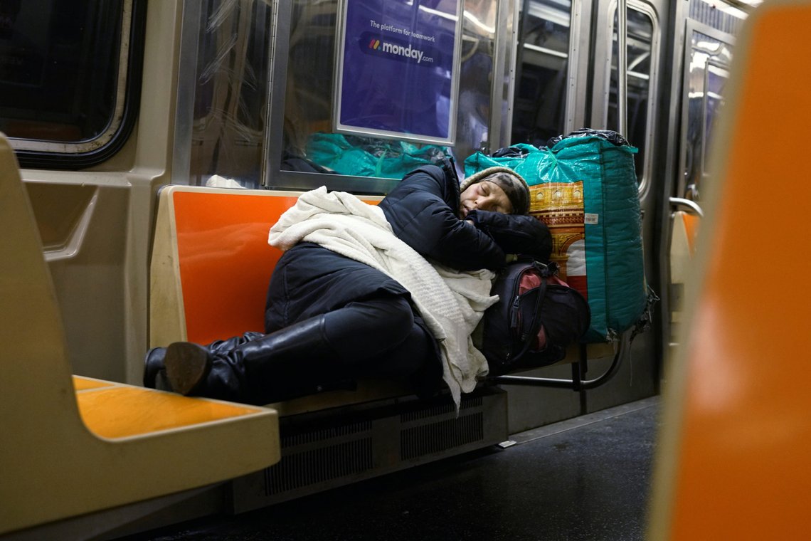 A woman sleeps on a New York subway train as the outbreak of the coronavirus continues in New York, U.S., April 13, 2020. Picture taken April 13, 2020. REUTERS/Lucas Jackson To match Special Report HEALTH-CORONAVIRUS/NEWYORK-HOMELESS A woman sleeps on a New York subway train as the outbreak of the coronavirus continues in New York, U.S., April 13, 2020. Picture taken April 13, 2020. REUTERS/Lucas Jackson To match Special Report HEALTH-CORONAVIRUS/NEWYORK-HOMELESS