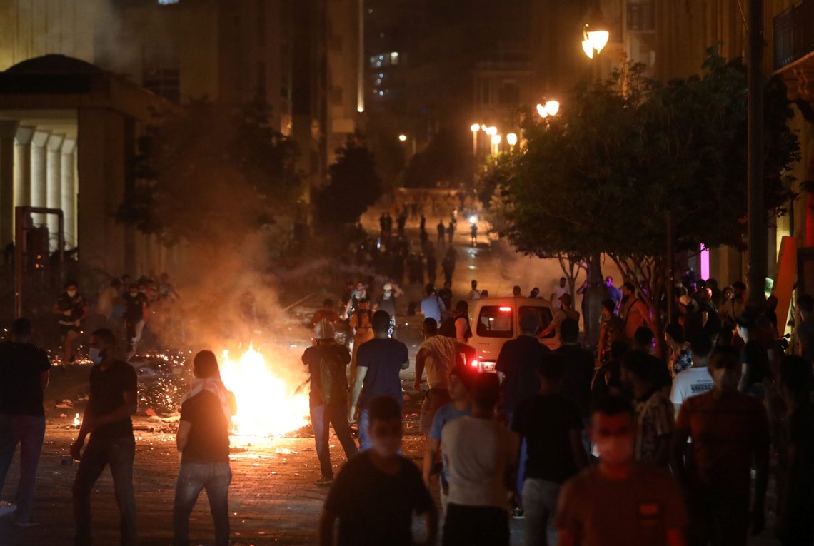 Demonstrators stand near burning fire during a protest near parliament, following Tuesday's blast in Beirut's port area, Lebanon August 7, 2020. REUTERS/Mohamed Azakir Demonstrators stand near burning fire during a protest near parliament, following Tuesday's blast in Beirut's port area, Lebanon August 7, 2020. REUTERS/Mohamed Azakir