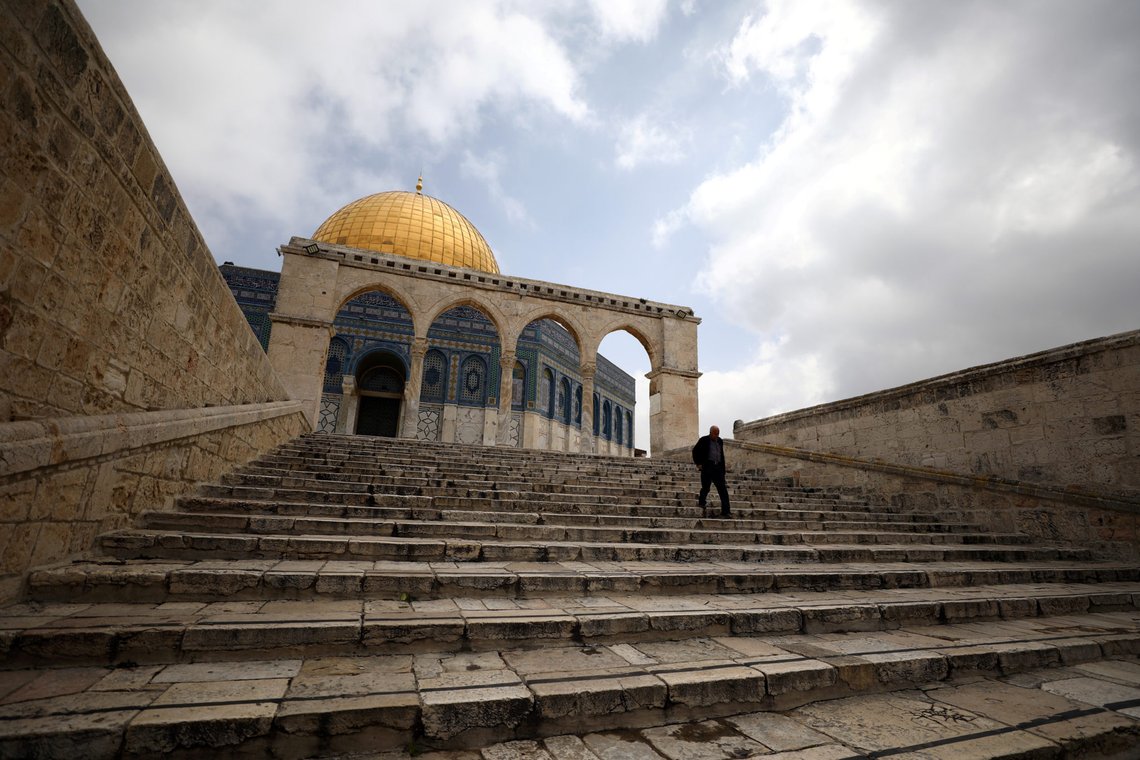 FILE PHOTO: A man walks in front of the Dome of the Rock in the compound known to Muslims as Noble Sanctuary and to Jews as Temple Mount in Jerusalem's Old City, after Muslim clerics shut the doors of Al-Aqsa mosque and the Dome of the Rock until further notice as a precaution against coronavirus March 15, 2020. REUTERS/Ammar Awad/ FIle Photo FILE PHOTO: A man walks in front of the Dome of the Rock in the compound known to Muslims as Noble Sanctuary and to Jews as Temple Mount in Jerusalem's Old City, after Muslim clerics shut the doors of Al-Aqsa mosque and the Dome of the Rock until further notice as a precaution against coronavirus March 15, 2020. REUTERS/Ammar Awad/ FIle Photo