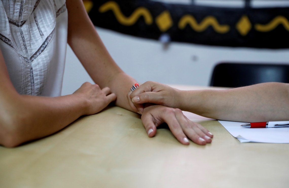 A domestic abuse victim, whose face cannot be seen to protect her identity, attends a personal consultation with an activist at Rome's 'Lucha y Siesta' (Fight and Rest) women's house, a building run solely by activists to look after women suffering from domestic violence in the city. The woman has been living at Lucha since the end of April, in Rome, Italy, July 9, 2020. 'Lucha y Siesta' has been a crucial lifeline for women suffering from domestic violence and abuse in the city for 12 years, helping and supporting over 1,200 women and around 400 children. The previously abandoned building was occupied and transformed by women's rights activists in 2008, who also use to the space to hold workshops and training for all ages on how to fight gender violence. It is now under threat and risk of closure as owners of the building, the city's heavily indebted public transport company ATAC, plan to sell it for around 2.6 million euros to claw back some much needed finances. During lockdown, 'Lucha y Siesta' had a 30 percent increase in requests for help, and had to come up with alternative ways to accommodate the emergency situation after local authorities threatened to cut electricity and water in the building in an effort to push the women out. Volunteers warn losing the beds available will restrict critical help for vulnerable women in the Italian capital. The entire city of Rome has only 39 beds available for women escaping violence and Lucha y Siesta makes up 14 of those. Three women arrived at Lucha during lockdown. Picture taken July 9, 2020. REUTERS/Yara Nardi A domestic abuse victim, whose face cannot be seen to protect her identity, attends a personal consultation with an activist at Rome's 'Lucha y Siesta' (Fight and Rest) women's house, a building run solely by activists to look after women suffering from domestic violence in the city. The woman has been living at Lucha since the end of April, in Rome, Italy, July 9, 2020. 'Lucha y Siesta' has been a crucial lifeline for women suffering from domestic violence and abuse in the city for 12 years, helping and supporting over 1,200 women and around 400 children. The previously abandoned building was occupied and transformed by women's rights activists in 2008, who also use to the space to hold workshops and training for all ages on how to fight gender violence. It is now under threat and risk of closure as owners of the building, the city's heavily indebted public transport company ATAC, plan to sell it for around 2.6 million euros to claw back some much needed finances. During lockdown, 'Lucha y Siesta' had a 30 percent increase in requests for help, and had to come up with alternative ways to accommodate the emergency situation after local authorities threatened to cut electricity and water in the building in an effort to push the women out. Volunteers warn losing the beds available will restrict critical help for vulnerable women in the Italian capital. The entire city of Rome has only 39 beds available for women escaping violence and Lucha y Siesta makes up 14 of those. Three women arrived at Lucha during lockdown. Picture taken July 9, 2020. REUTERS/Yara Nardi