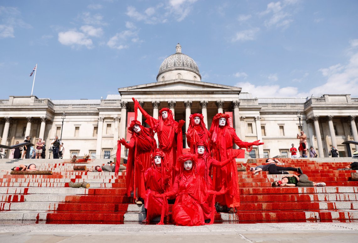Activists stand in front of the National Gallery after pouring fake blood on steps during a protest over the impact of the coronavirus disease (COVID-19) on Brazil's indigenous communities, in London, Britain, August 9, 2020. REUTERS/John Sibley Activists stand in front of the National Gallery after pouring fake blood on steps during a protest over the impact of the coronavirus disease (COVID-19) on Brazil's indigenous communities, in London, Britain, August 9, 2020. REUTERS/John Sibley