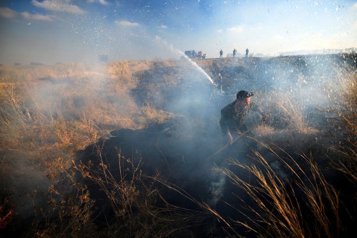 Israeli soldiers try to extinguish fire in an area where Palestinians have been causing blazes by flying balloons loaded with flammable materials, on the Israeli side of the border between Israel and the Gaza Strip August 21, 2020. REUTERS/Amir Cohen TPX IMAGES OF THE DAY Israeli soldiers try to extinguish fire in an area where Palestinians have been causing blazes by flying balloons loaded with flammable materials, on the Israeli side of the border between Israel and the Gaza Strip August 21, 2020. REUTERS/Amir Cohen TPX IMAGES OF THE DAY