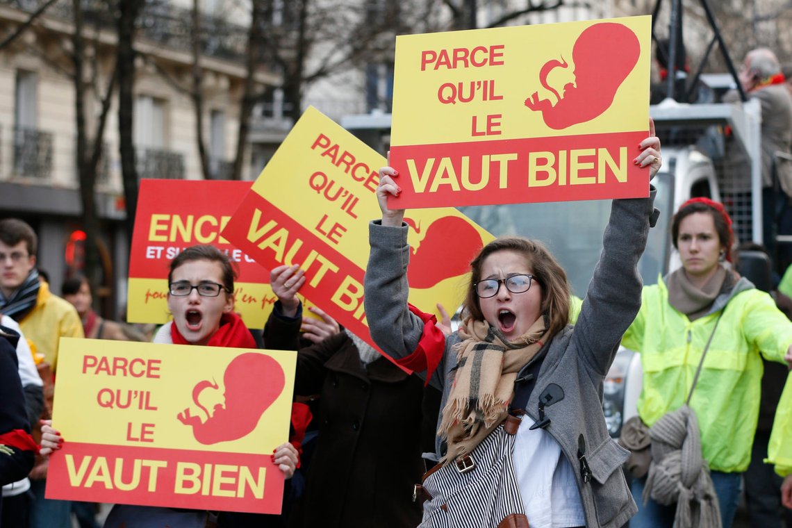 Young women carry signs as they attend the "Marche Pour la Vie" (March for Life) anti-abortion protest march on the eve of an ammendment vote at the National Assembly in Paris, January 19, 2014. Signs reads, in reference to an advertisement for a famous cosmetics company, "Because it (the foetus) is worth it ". REUTERS/Gonzalo Fuentes (FRANCE - Tags: POLITICS) Young women carry signs as they attend the "Marche Pour la Vie" (March for Life) anti-abortion protest march on the eve of an ammendment vote at the National Assembly in Paris, January 19, 2014. Signs reads, in reference to an advertisement for a famous cosmetics company, "Because it (the foetus) is worth it ". REUTERS/Gonzalo Fuentes (FRANCE - Tags: POLITICS)