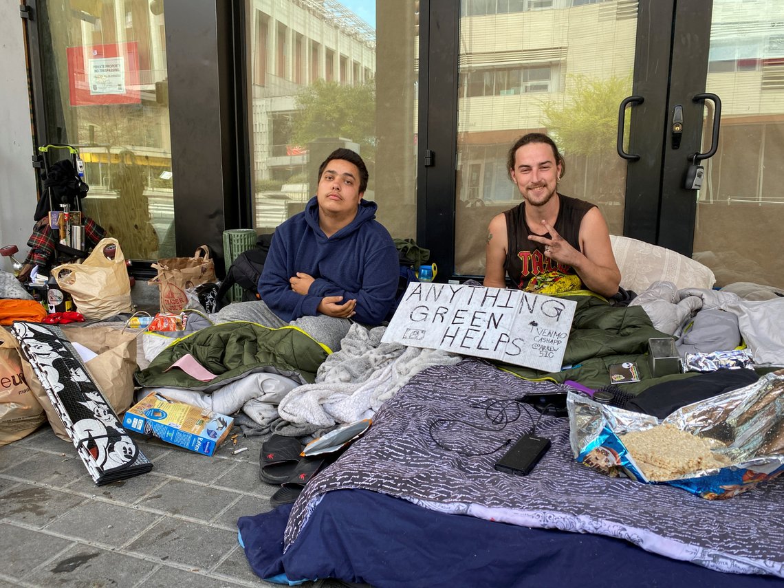 Ross Standley, 23, and James Sears, 27, sit outside an under construction restaurant in Berkeley, California March 20, 2020. The homeless individuals have seen their income from panhandling significant decrease in the last week as the coronavirus disease (COVID-19) outbreak has emptied streets in the university town. REUTERS/Paresh Dave Ross Standley, 23, and James Sears, 27, sit outside an under construction restaurant in Berkeley, California March 20, 2020. The homeless individuals have seen their income from panhandling significant decrease in the last week as the coronavirus disease (COVID-19) outbreak has emptied streets in the university town. REUTERS/Paresh Dave