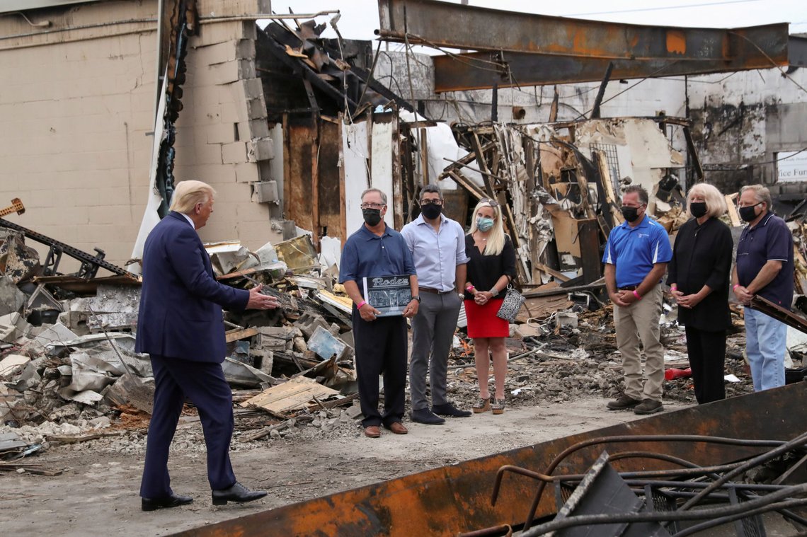 U.S. President Donald Trump talks with local business people while examining property damage to a Kenosha business in the aftermath of recent protests against police brutality and racial injustice and ensuing violence after the shooting of Jacob Blake by a police officer in Kenosha, Wisconsin, U.S., September 1, 2020. REUTERS/Leah Millis TPX IMAGES OF THE DAY U.S. President Donald Trump talks with local business people while examining property damage to a Kenosha business in the aftermath of recent protests against police brutality and racial injustice and ensuing violence after the shooting of Jacob Blake by a police officer in Kenosha, Wisconsin, U.S., September 1, 2020. REUTERS/Leah Millis TPX IMAGES OF THE DAY