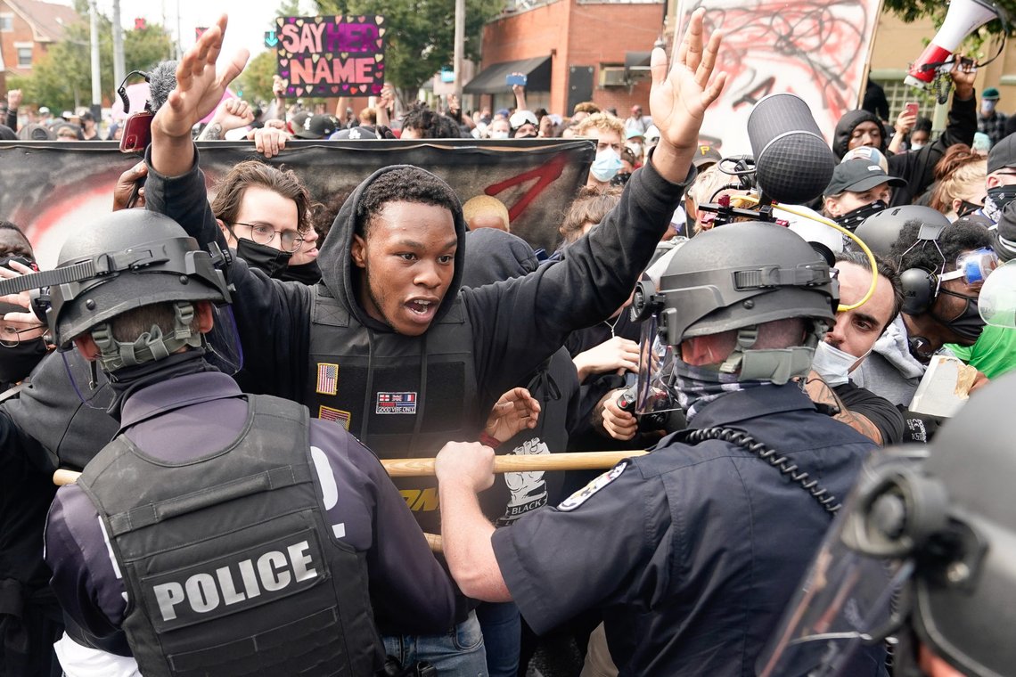 A protester clashes with police after a grand jury considering the March killing of Breonna Taylor, a Black medical worker, in her home in Louisville, Kentucky, voted to indict one of three white police officers for wanton endangerment, in Louisville, Kentucky, U.S. September 23, 2020. REUTERS/Bryan Woolston A protester clashes with police after a grand jury considering the March killing of Breonna Taylor, a Black medical worker, in her home in Louisville, Kentucky, voted to indict one of three white police officers for wanton endangerment, in Louisville, Kentucky, U.S. September 23, 2020. REUTERS/Bryan Woolston