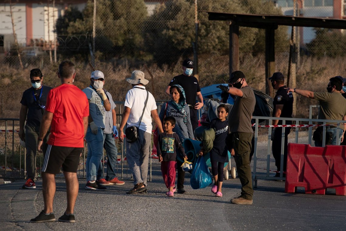 A family from the destroyed Moria camp for refugees and migrants arrives at a new temporary camp, on the island of Lesbos, Greece, September 14, 2020. REUTERS/Alkis Konstantinidis A family from the destroyed Moria camp for refugees and migrants arrives at a new temporary camp, on the island of Lesbos, Greece, September 14, 2020. REUTERS/Alkis Konstantinidis