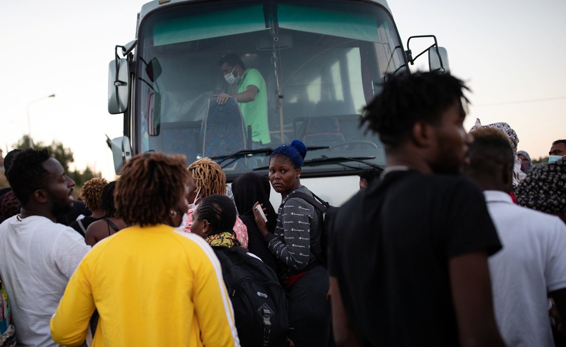 Refugees and migrants wait to board a bus following a fire at the Moria camp on the island of Lesbos, Greece, September 10, 2020. REUTERS/Alkis Konstantinidis Refugees and migrants wait to board a bus following a fire at the Moria camp on the island of Lesbos, Greece, September 10, 2020. REUTERS/Alkis Konstantinidis