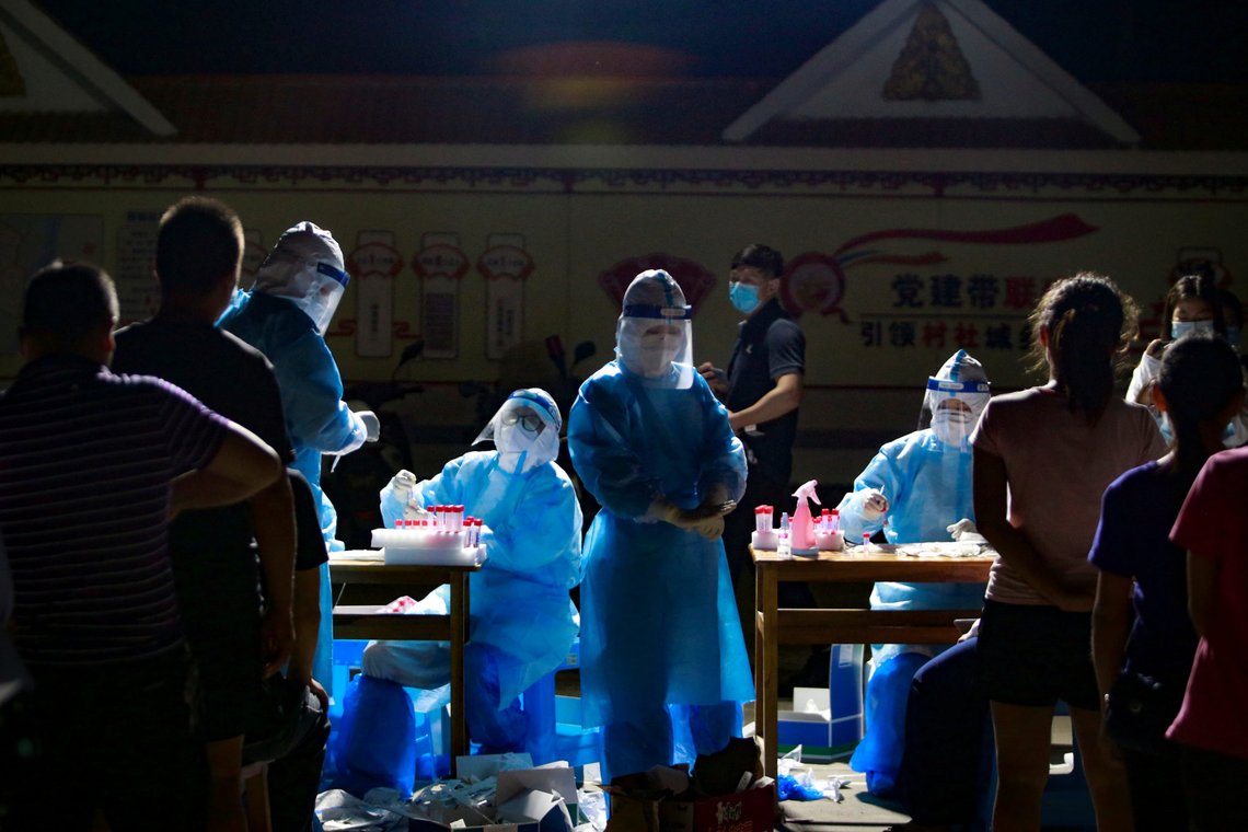 Medical workers in protective suits attend to people lining up for nucleic acid testing at a residential compound, following imported coronavirus disease (COVID-19) infections from neighbouring Myanmar, in the border city of Ruili, Dehong prefecture, Yunnan province, China September 16, 2020. Picture taken September 16, 2020. cnsphoto via REUTERS ATTENTION EDITORS - THIS IMAGE WAS PROVIDED BY A THIRD PARTY. CHINA OUT. Medical workers in protective suits attend to people lining up for nucleic acid testing at a residential compound, following imported coronavirus disease (COVID-19) infections from neighbouring Myanmar, in the border city of Ruili, Dehong prefecture, Yunnan province, China September 16, 2020. Picture taken September 16, 2020. cnsphoto via REUTERS ATTENTION EDITORS - THIS IMAGE WAS PROVIDED BY A THIRD PARTY. CHINA OUT.