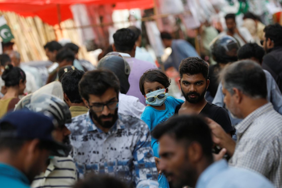A girl, wearing a protective mask, and her father are seen in a rush of people, ahead of Pakistan's Independence Day, as the coronavirus disease (COVID-19) pandemic continues, in Karachi, Pakistan August 9, 2020. REUTERS/Akhtar Soomro A girl, wearing a protective mask, and her father are seen in a rush of people, ahead of Pakistan's Independence Day, as the coronavirus disease (COVID-19) pandemic continues, in Karachi, Pakistan August 9, 2020. REUTERS/Akhtar Soomro
