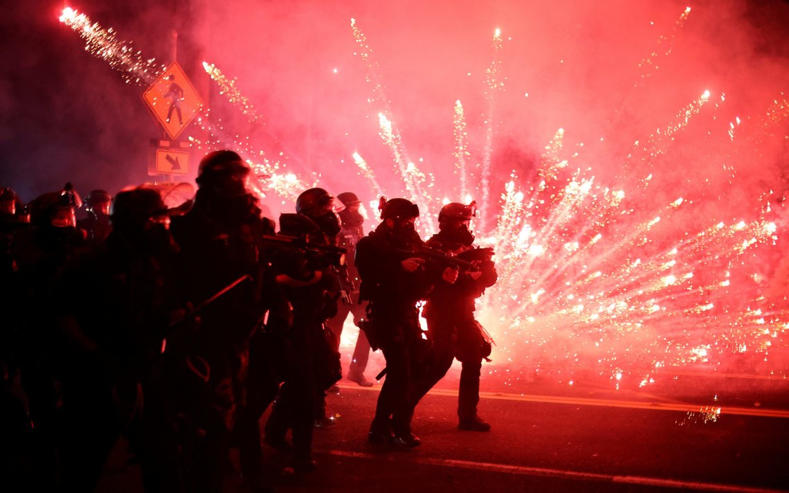 Police advance on protesters to clear a street on the 100th consecutive night of protests against police violence and racial inequality, in Portland, Oregon, U.S. September 5, 2020. REUTERS/Carlos Barria TPX IMAGES OF THE DAY Police advance on protesters to clear a street on the 100th consecutive night of protests against police violence and racial inequality, in Portland, Oregon, U.S. September 5, 2020. REUTERS/Carlos Barria TPX IMAGES OF THE DAY