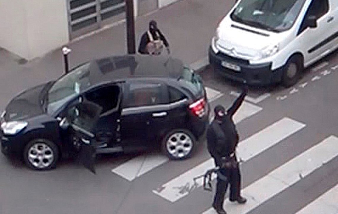 FILE PHOTO - Gunmen gesture as they return to their car after the attack outside the offices of French satirical weekly newspaper Charlie Hebdo (seen at rear) in this still image taken from amateur video shot in Paris January 7, 2015. REUTERS/Reuters TV/File Photo FILE PHOTO - Gunmen gesture as they return to their car after the attack outside the offices of French satirical weekly newspaper Charlie Hebdo (seen at rear) in this still image taken from amateur video shot in Paris January 7, 2015. REUTERS/Reuters TV/File Photo