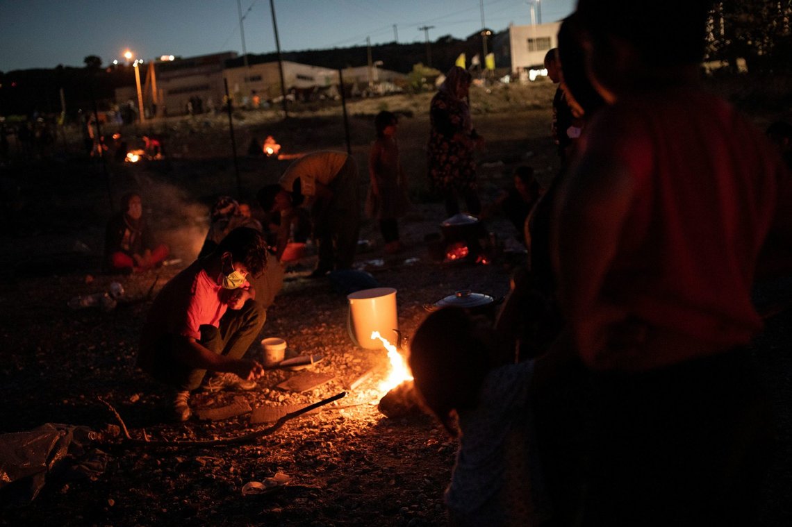 Refugees and migrants from the destroyed Moria camp cook over a fire, on the island of Lesbos, Greece, 11, 2020. REUTERS/Alkis Konstantinidis Refugees and migrants from the destroyed Moria camp cook over a fire, on the island of Lesbos, Greece, 11, 2020. REUTERS/Alkis Konstantinidis
