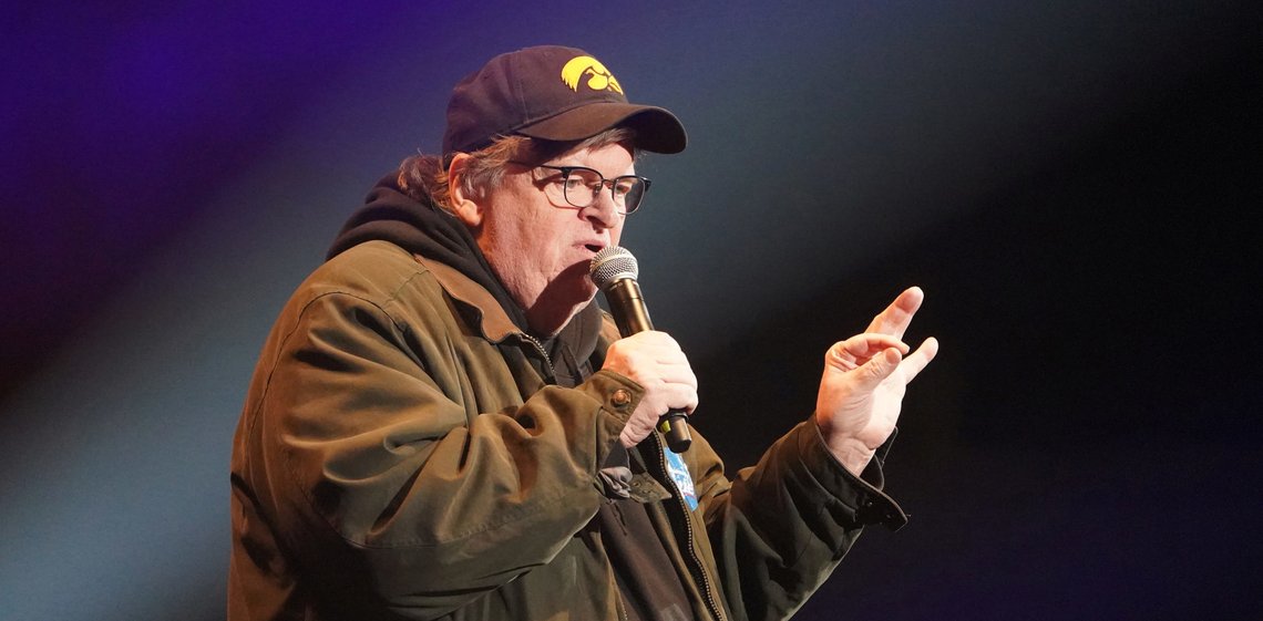 FILE PHOTO: Director Michael Moore speaks during a rally by U.S. Democratic presidential candidate Senator Bernie Sanders in Cedar Rapids, Iowa, U.S., February 1, 2020. REUTERS/Carlo Allegri/File Photo FILE PHOTO: Director Michael Moore speaks during a rally by U.S. Democratic presidential candidate Senator Bernie Sanders in Cedar Rapids, Iowa, U.S., February 1, 2020. REUTERS/Carlo Allegri/File Photo