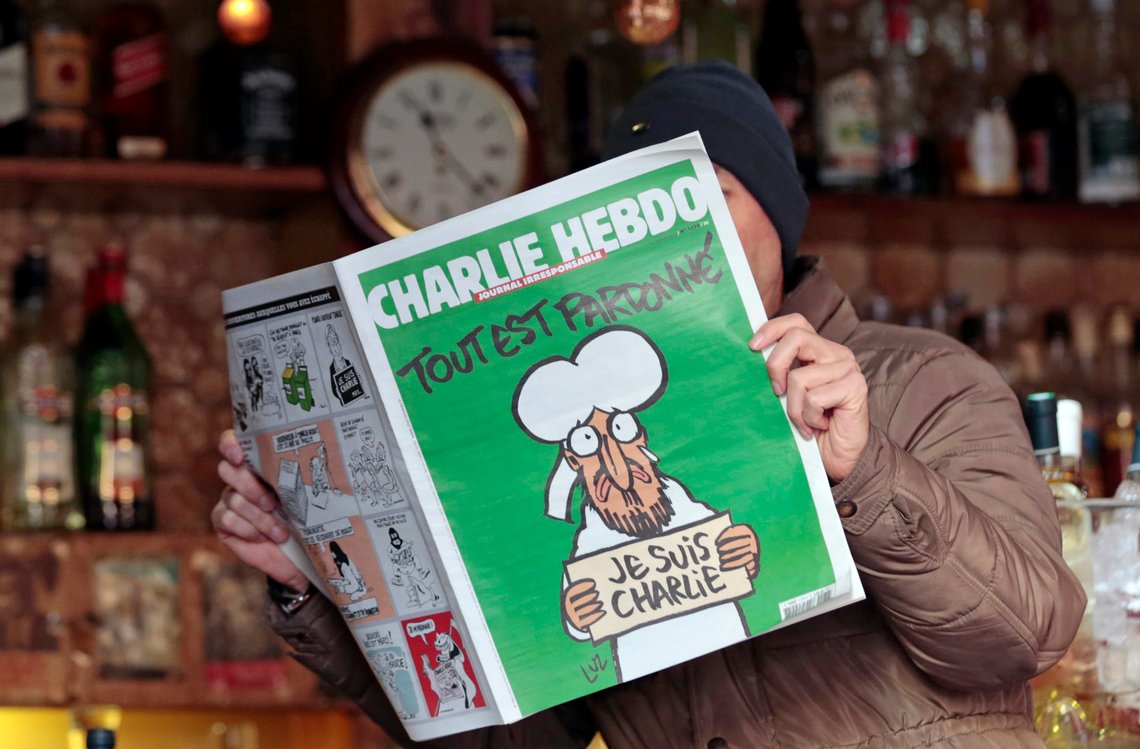 ATTENTION EDITORS - THIS PICTURE MAY OFFEND SOME PEOPLE
A man poses with the new issue of French satirical weekly Charlie Hebdo entitled "Tout est pardonne" ("All is forgiven"), which shows a caricature of Prophet Mohammad, at a cafe in Nice, southern France January 14, 2015. The first edition of Charlie Hebdo published after the deadly attacks by Islamist gunmen sold out within minutes at newspaper kiosks around France on Wednesday, with people queuing up to buy copies to support the satirical weekly. A print run of up to three million copies has been set for what has been called "the survivors' edition," dwarfing the usual 60,000 run. REUTERS/Eric Gaillard (FRANCE - Tags: CRIME LAW MEDIA) TEMPLATE OUT ATTENTION EDITORS - THIS PICTURE MAY OFFEND SOME PEOPLE
A man poses with the new issue of French satirical weekly Charlie Hebdo entitled "Tout est pardonne" ("All is forgiven"), which shows a caricature of Prophet Mohammad, at a cafe in Nice, southern France January 14, 2015. The first edition of Charlie Hebdo published after the deadly attacks by Islamist gunmen sold out within minutes at newspaper kiosks around France on Wednesday, with people queuing up to buy copies to support the satirical weekly. A print run of up to three million copies has been set for what has been called "the survivors' edition," dwarfing the usual 60,000 run. REUTERS/Eric Gaillard (FRANCE - Tags: CRIME LAW MEDIA) TEMPLATE OUT