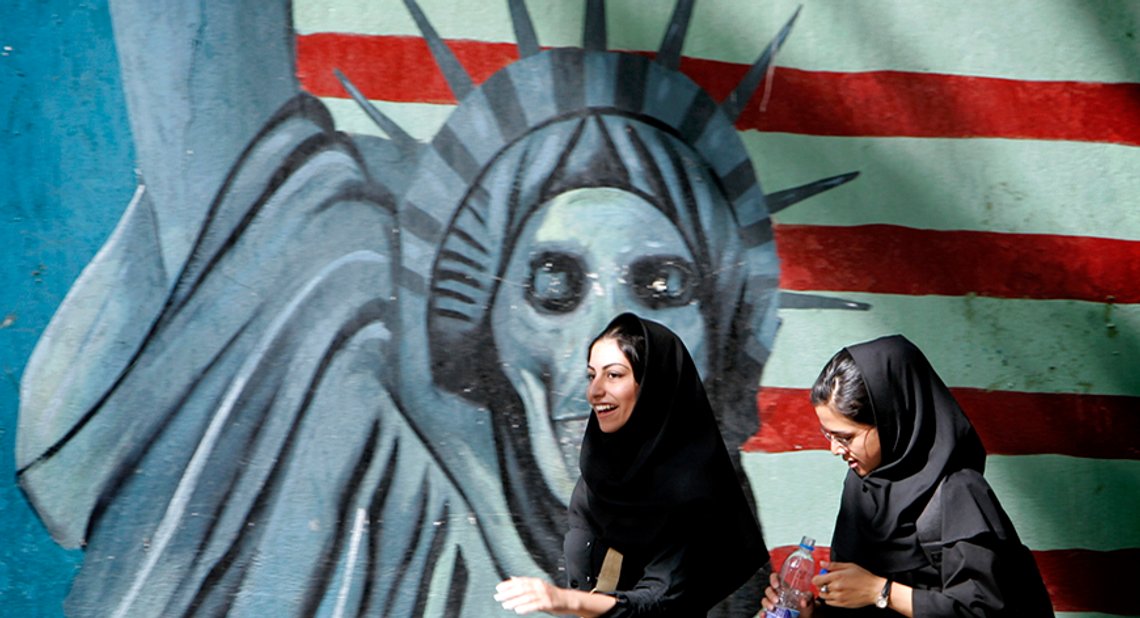 Iranian women walk past a satirical mural of the Statue of Liberty on the wall of former U.S. embassy in Tehran, Iran April 16, 2006. REUTERS/Morteza Nikoubazl - RTR1CJLR Iranian women walk past a satirical mural of the Statue of Liberty on the wall of former U.S. embassy in Tehran, Iran April 16, 2006. REUTERS/Morteza Nikoubazl - RTR1CJLR