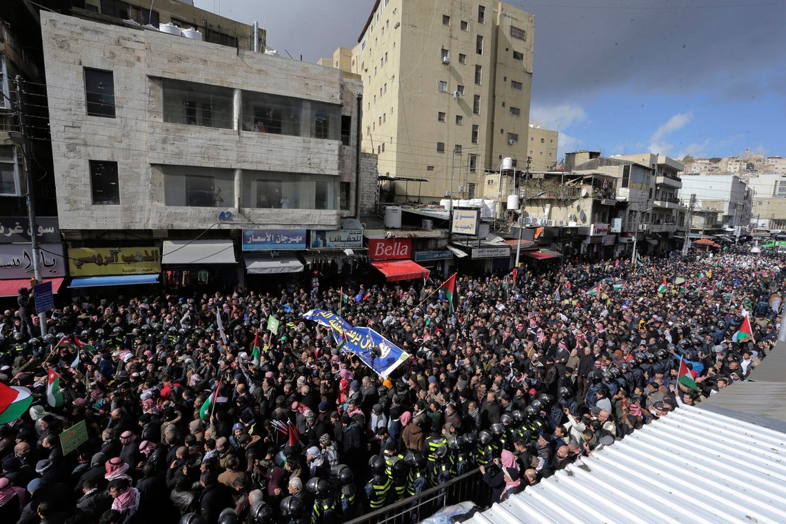 Protesters carry Jordanian and Palestinian flags and slogans during a protest against the Middle East peace plan proposed by U.S. President Donald Trump, in the center of Amman, Jordan, Friday, Jan. 31, 2020. (AP Photo/Raad Adayleh) Protesters carry Jordanian and Palestinian flags and slogans during a protest against the Middle East peace plan proposed by U.S. President Donald Trump, in the center of Amman, Jordan, Friday, Jan. 31, 2020. (AP Photo/Raad Adayleh)