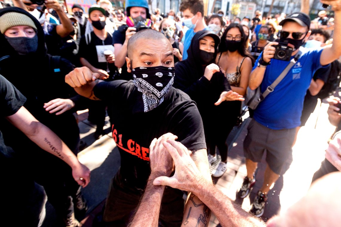 A counter-protester, who declined to give his name, prepares to hit a conservative free speech rally organizer in San Francisco on Saturday, Oct. 17, 2020. About a dozen pro-Trump demonstrators were met by several hundred counter-protesters as they tried to rally. (AP Photo/Noah Berger) A counter-protester, who declined to give his name, prepares to hit a conservative free speech rally organizer in San Francisco on Saturday, Oct. 17, 2020. About a dozen pro-Trump demonstrators were met by several hundred counter-protesters as they tried to rally. (AP Photo/Noah Berger)