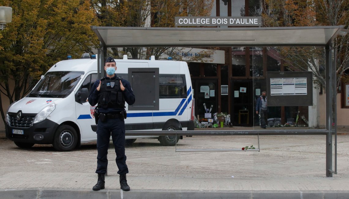 A riot police officer guards the school where a history teacher had discussed caricatures of Islam's Prophet Muhammad with his class, Saturday, Oct. 17, 2020 in Conflans-Sainte-Honorine, northwest of Paris. French President Emmanuel Macron denounced what he called an "Islamist terrorist attack" against a history teacher decapitated in a Paris suburb Friday, urging the nation to stand united against extremism. The suspected attacker was shot to death by police after Friday's beheading. (AP Photo/Michel Euler) A riot police officer guards the school where a history teacher had discussed caricatures of Islam's Prophet Muhammad with his class, Saturday, Oct. 17, 2020 in Conflans-Sainte-Honorine, northwest of Paris. French President Emmanuel Macron denounced what he called an "Islamist terrorist attack" against a history teacher decapitated in a Paris suburb Friday, urging the nation to stand united against extremism. The suspected attacker was shot to death by police after Friday's beheading. (AP Photo/Michel Euler)