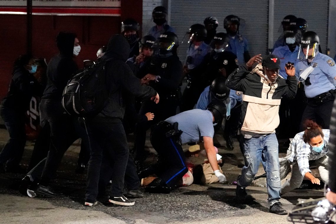 A man, center, is detained by Philadelphia police in Philadelphia, Tuesday, Oct. 27, 2020. Hundreds of demonstrators marched in West Philadelphia over the death of Walter Wallace Jr., a Black man who was killed by police in Philadelphia on Monday. Police shot and killed the 27-year-old on a Philadelphia street after yelling at him to drop his knife. (AP Photo/Matt Slocum) A man, center, is detained by Philadelphia police in Philadelphia, Tuesday, Oct. 27, 2020. Hundreds of demonstrators marched in West Philadelphia over the death of Walter Wallace Jr., a Black man who was killed by police in Philadelphia on Monday. Police shot and killed the 27-year-old on a Philadelphia street after yelling at him to drop his knife. (AP Photo/Matt Slocum)