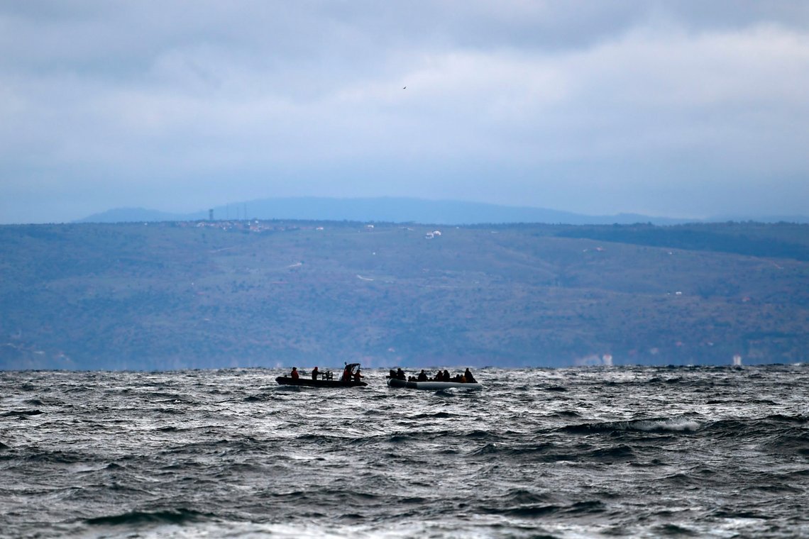 Migrants onboard a dinghy, right, accompanied by a vessel of Greek Navy warship try to approach the village of Skala Sikaminias, on the Greek island of Lesbos, after crossing the Aegean sea from Turkey, Saturday, Feb. 29, 2020. Hundreds of refugees and migrants in Turkey have begun heading for the country's land and sea borders with Greece, buoyed by Turkish officials' statements indicating they will not be hindered from crossing the frontier to head into Europe. (AP Photo/Michael Varaklas) Migrants onboard a dinghy, right, accompanied by a vessel of Greek Navy warship try to approach the village of Skala Sikaminias, on the Greek island of Lesbos, after crossing the Aegean sea from Turkey, Saturday, Feb. 29, 2020. Hundreds of refugees and migrants in Turkey have begun heading for the country's land and sea borders with Greece, buoyed by Turkish officials' statements indicating they will not be hindered from crossing the frontier to head into Europe. (AP Photo/Michael Varaklas)