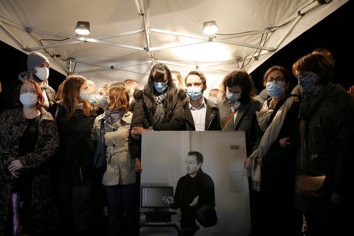 People hold a photo of the history teacher Samuel Paty , who was beheaded last week, during a memorial march in homage to him, Tuesday, Oct.20, 2020 in Conflans-Sainte-Honorine, northwest of Paris. Samuel Paty was beheaded on Friday by an 18-year-old Moscow-born Chechen refugee, who was later shot dead by police. Police officials said Paty had discussed caricatures of Islam's Prophet Muhammad with his class, leading to threats. (AP Photo/Lewis Joly) People hold a photo of the history teacher Samuel Paty , who was beheaded last week, during a memorial march in homage to him, Tuesday, Oct.20, 2020 in Conflans-Sainte-Honorine, northwest of Paris. Samuel Paty was beheaded on Friday by an 18-year-old Moscow-born Chechen refugee, who was later shot dead by police. Police officials said Paty had discussed caricatures of Islam's Prophet Muhammad with his class, leading to threats. (AP Photo/Lewis Joly)
