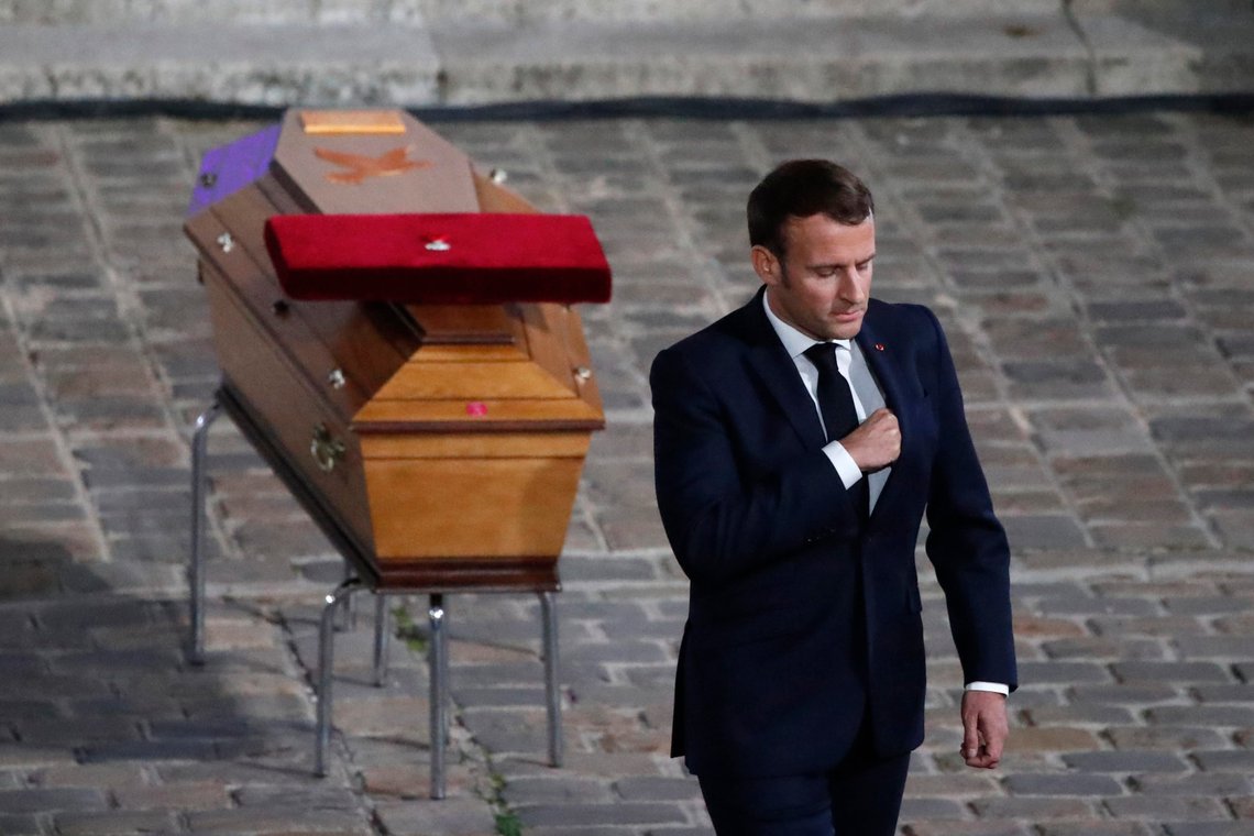 French President Emmanuel Macron leaves after paying his respects by the coffin of slain teacher Samuel Paty in the courtyard of the Sorbonne university during a national memorial event, Wednesday, Oct. 21, 2020 in Paris. French history teacher Samuel Paty was beheaded in Conflans-Sainte-Honorine, northwest of Paris, by a 18-year-old Moscow-born Chechen refugee, who was later shot dead by police. (AP Photo/Francois Mori, Pool) French President Emmanuel Macron leaves after paying his respects by the coffin of slain teacher Samuel Paty in the courtyard of the Sorbonne university during a national memorial event, Wednesday, Oct. 21, 2020 in Paris. French history teacher Samuel Paty was beheaded in Conflans-Sainte-Honorine, northwest of Paris, by a 18-year-old Moscow-born Chechen refugee, who was later shot dead by police. (AP Photo/Francois Mori, Pool)