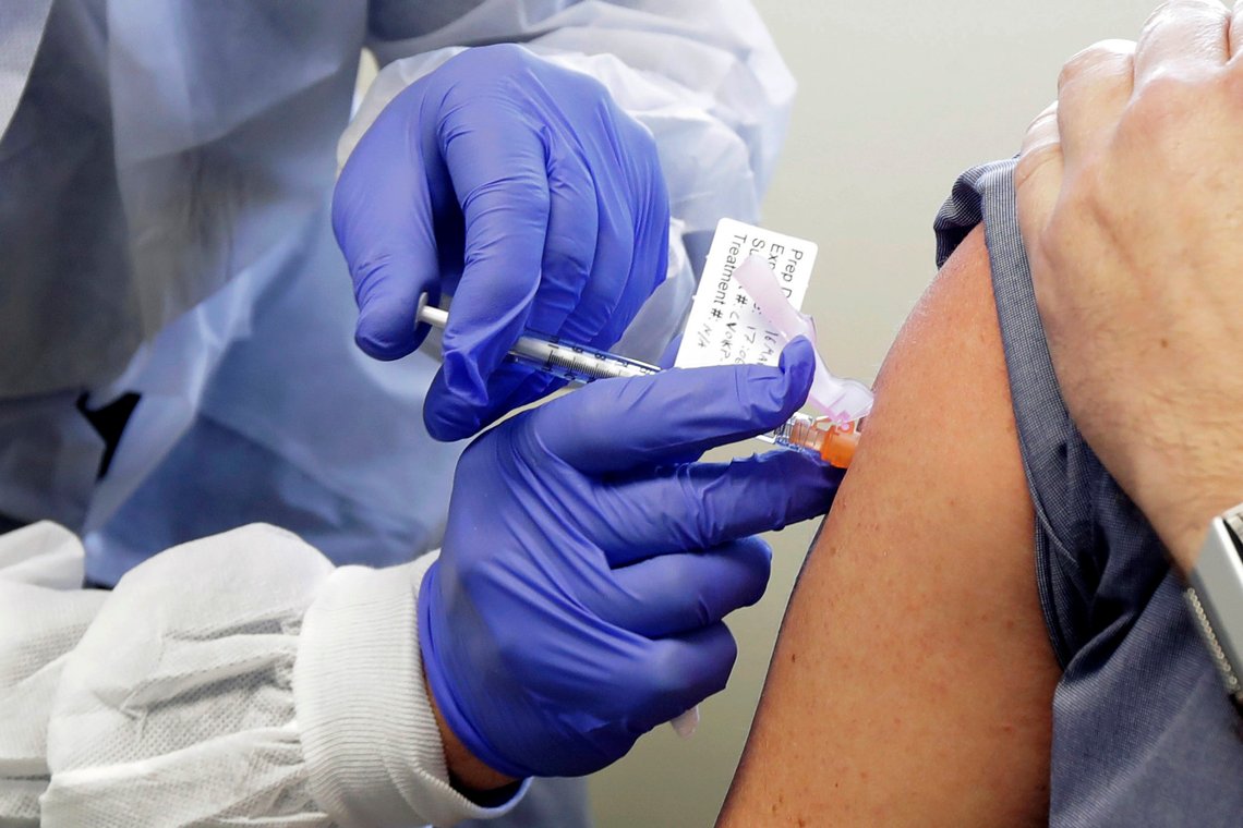 FILE - In this March 16, 2020, file photo, Neal Browning receives a shot in the first-stage safety study clinical trial of a potential vaccine for COVID-19, the disease caused by the new coronavirus, at the Kaiser Permanente Washington Health Research Institute in Seattle. The Food and Drug Administration laid out updated safety standards Tuesday, Oct. 6, for makers of COVID-19 vaccines after the White House blocked their formal release, the latest political tug-of-war between the Trump administration and the governments public health scientists. (AP Photo/Ted S. Warren, File) FILE - In this March 16, 2020, file photo, Neal Browning receives a shot in the first-stage safety study clinical trial of a potential vaccine for COVID-19, the disease caused by the new coronavirus, at the Kaiser Permanente Washington Health Research Institute in Seattle. The Food and Drug Administration laid out updated safety standards Tuesday, Oct. 6, for makers of COVID-19 vaccines after the White House blocked their formal release, the latest political tug-of-war between the Trump administration and the governments public health scientists. (AP Photo/Ted S. Warren, File)