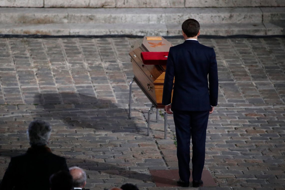 French President Emmanuel Macron pays his respects by the coffin of slain teacher Samuel Paty in the courtyard of the Sorbonne university during a national memorial event, Wednesday, Oct. 21, 2020 in Paris. French history teacher Samuel Paty was beheaded in Conflans-Sainte-Honorine, northwest of Paris, by a 18-year-old Moscow-born Chechen refugee, who was later shot dead by police. (AP Photo/Francois Mori, Pool) French President Emmanuel Macron pays his respects by the coffin of slain teacher Samuel Paty in the courtyard of the Sorbonne university during a national memorial event, Wednesday, Oct. 21, 2020 in Paris. French history teacher Samuel Paty was beheaded in Conflans-Sainte-Honorine, northwest of Paris, by a 18-year-old Moscow-born Chechen refugee, who was later shot dead by police. (AP Photo/Francois Mori, Pool)