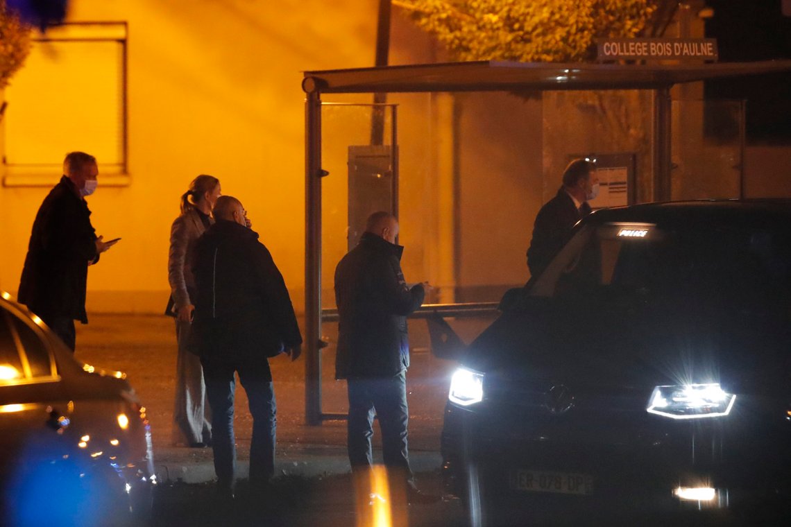 French police officers gather outside a high school after a history teacher who opened a discussion with students on caricatures of Islam's Prophet Muhammad was beheaded, Friday, Oct. 16, 2020 in Conflans-Saint-Honorine, north of Paris. Police have shot the suspected killer dead. (AP Photo/Michel Euler) French police officers gather outside a high school after a history teacher who opened a discussion with students on caricatures of Islam's Prophet Muhammad was beheaded, Friday, Oct. 16, 2020 in Conflans-Saint-Honorine, north of Paris. Police have shot the suspected killer dead. (AP Photo/Michel Euler)