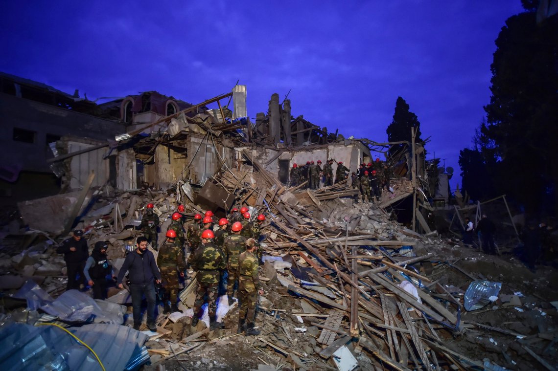 Soldiers and firefighters search for survivors in a residential area that was hit by rocket fire overnight by Armenian forces, early Sunday, Oct. 11, 2020, in Ganja, Azerbaijan's second largest city, near the border with Armenia. Several civilians were killed and dozens were wounded. Russian President Vladimir Putin brokered a cease-fire on Friday in a series of calls with President Ilham Aliyev of Azerbaijan and Armenia's Prime Minister Nikol Pashinian.(Ismail Coskun/IHA via AP) Soldiers and firefighters search for survivors in a residential area that was hit by rocket fire overnight by Armenian forces, early Sunday, Oct. 11, 2020, in Ganja, Azerbaijan's second largest city, near the border with Armenia. Several civilians were killed and dozens were wounded. Russian President Vladimir Putin brokered a cease-fire on Friday in a series of calls with President Ilham Aliyev of Azerbaijan and Armenia's Prime Minister Nikol Pashinian.(Ismail Coskun/IHA via AP)
