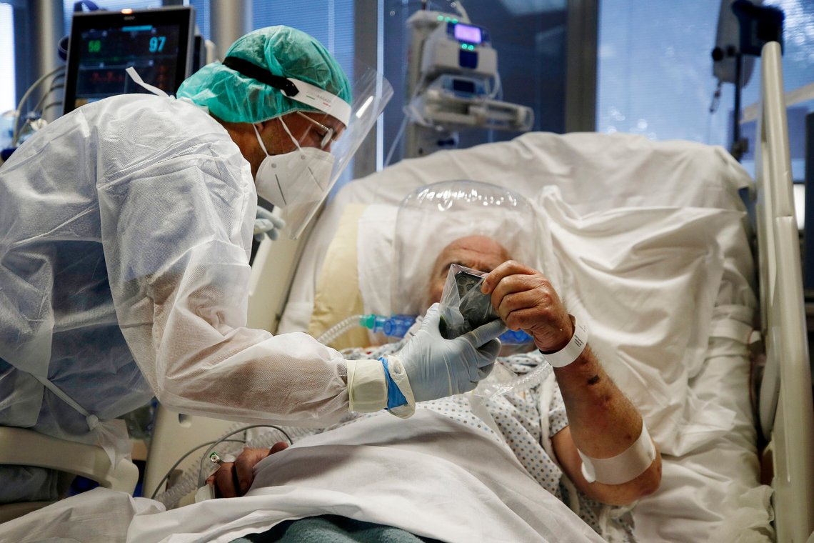 Medics tend to a COVID-19 patient at the intensive care unit of Casal Palocco hospital in Rome Tuesday, Oct. 20, 2020. The new surge of cases requiring hospitalization is causing worries in the Country that suffered the second highest toll in Europe during the Spring, as 10,874 new cases and 89 victims were registered today. (Cecilia Fabiano/LaPresse via AP) Medics tend to a COVID-19 patient at the intensive care unit of Casal Palocco hospital in Rome Tuesday, Oct. 20, 2020. The new surge of cases requiring hospitalization is causing worries in the Country that suffered the second highest toll in Europe during the Spring, as 10,874 new cases and 89 victims were registered today. (Cecilia Fabiano/LaPresse via AP)