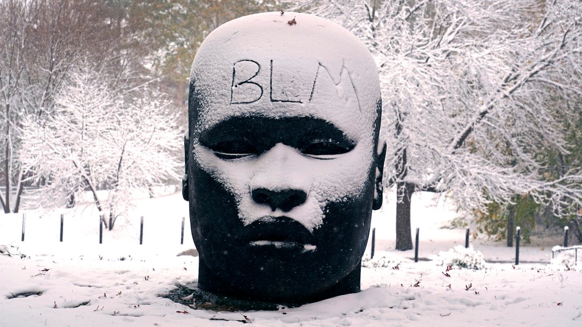 The abbreviation "BLM", for the Black Lives Matter movement, written on the forehead of the "Eternal Presence" statue outside the National Center of Afro-American Artists, Friday, Oct. 30, 2020, in the Roxbury neighborhood of Boston. The Boston area was blanketed with a few inches of snow during the day. (AP Photo/Charles Krupa) The abbreviation "BLM", for the Black Lives Matter movement, written on the forehead of the "Eternal Presence" statue outside the National Center of Afro-American Artists, Friday, Oct. 30, 2020, in the Roxbury neighborhood of Boston. The Boston area was blanketed with a few inches of snow during the day. (AP Photo/Charles Krupa)