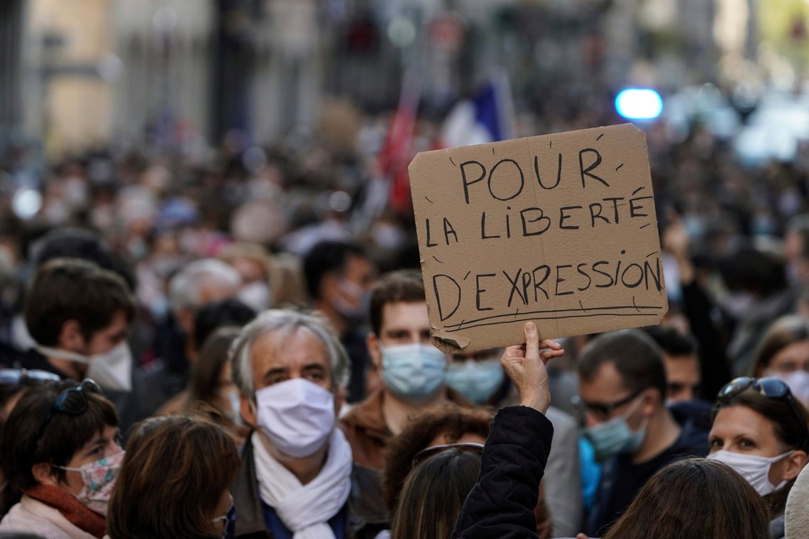 A person holds up a banner that reads: 'For the freedom of speech', during a demonstration in Lyon, central France, Sunday, Oct. 18, 2020. Demonstrators in France on Sunday took part in gatherings in support of freedom of speech and in tribute to a history teacher who was beheaded near Paris after discussing caricatures of Islams Prophet Muhammad with his class. (AP Photo/Laurent Cipriani) A person holds up a banner that reads: 'For the freedom of speech', during a demonstration in Lyon, central France, Sunday, Oct. 18, 2020. Demonstrators in France on Sunday took part in gatherings in support of freedom of speech and in tribute to a history teacher who was beheaded near Paris after discussing caricatures of Islams Prophet Muhammad with his class. (AP Photo/Laurent Cipriani)
