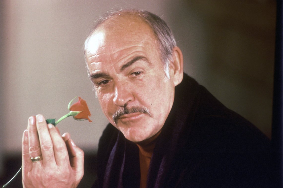 FILE - In this Jan. 23, 1987 file photo, actor Sean Connery holds a rose in his hand as he talks about his new movie "The Name of the Rose" at a news conference in London. Scottish actor Sean Connery, considered by many to have been the best James Bond, has died aged 90, according to an announcement from his family. (AP Photo/Gerald Penny, File) FILE - In this Jan. 23, 1987 file photo, actor Sean Connery holds a rose in his hand as he talks about his new movie "The Name of the Rose" at a news conference in London. Scottish actor Sean Connery, considered by many to have been the best James Bond, has died aged 90, according to an announcement from his family. (AP Photo/Gerald Penny, File)