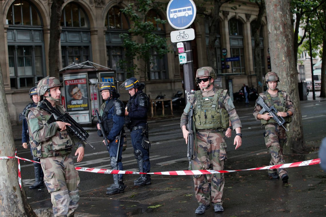 FILE - In this June 6, 2017 file photo, police officers and soldiers seal off the access to Notre Dame cathedral after a man attacked officers with a hammer while patrolling the esplanade in front of the famous landmark, in Paris. A Paris court on Wednesday jailed an Algerian former doctoral student for 28 years after convicting him of attempted terrorist murder for attacking police guarding Notre Dame Cathedral with a hammer, crying: "This is for Syria!". Farid Ikken's 2017 assault outside one of France's most-visited monuments came after a string of Islamic extremist attacks around France in 2015-2016, and was among multiple violent acts targeting security forces. (AP Photo/Christophe Ena, File) FILE - In this June 6, 2017 file photo, police officers and soldiers seal off the access to Notre Dame cathedral after a man attacked officers with a hammer while patrolling the esplanade in front of the famous landmark, in Paris. A Paris court on Wednesday jailed an Algerian former doctoral student for 28 years after convicting him of attempted terrorist murder for attacking police guarding Notre Dame Cathedral with a hammer, crying: "This is for Syria!". Farid Ikken's 2017 assault outside one of France's most-visited monuments came after a string of Islamic extremist attacks around France in 2015-2016, and was among multiple violent acts targeting security forces. (AP Photo/Christophe Ena, File)