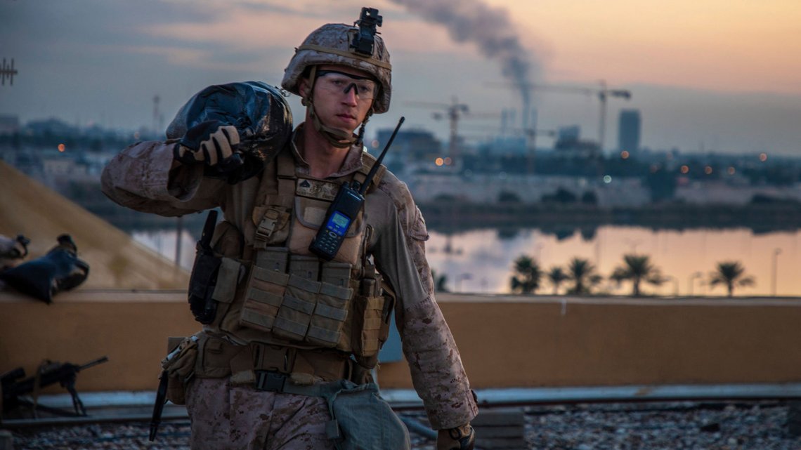 In this Saturday, Jan. 4, 2020, photo, released by the U.S. military, a U.S. Marine with 2nd Battalion, 7th Marines that is part of a quick reaction force, carries a sand bag during the reinforcement of the U.S. embassy compound in Baghdad, Iraq. The blowback over the U.S. killing of a top Iranian general mounted Sunday, Jan. 5 as Iraq's Parliament called for the expulsion of American troops from the country a move that could allow a resurgence of the Islamic State group. (U.S. Marine Corps photo by Sgt. Kyle C. Talbot via AP) In this Saturday, Jan. 4, 2020, photo, released by the U.S. military, a U.S. Marine with 2nd Battalion, 7th Marines that is part of a quick reaction force, carries a sand bag during the reinforcement of the U.S. embassy compound in Baghdad, Iraq. The blowback over the U.S. killing of a top Iranian general mounted Sunday, Jan. 5 as Iraq's Parliament called for the expulsion of American troops from the country a move that could allow a resurgence of the Islamic State group. (U.S. Marine Corps photo by Sgt. Kyle C. Talbot via AP)