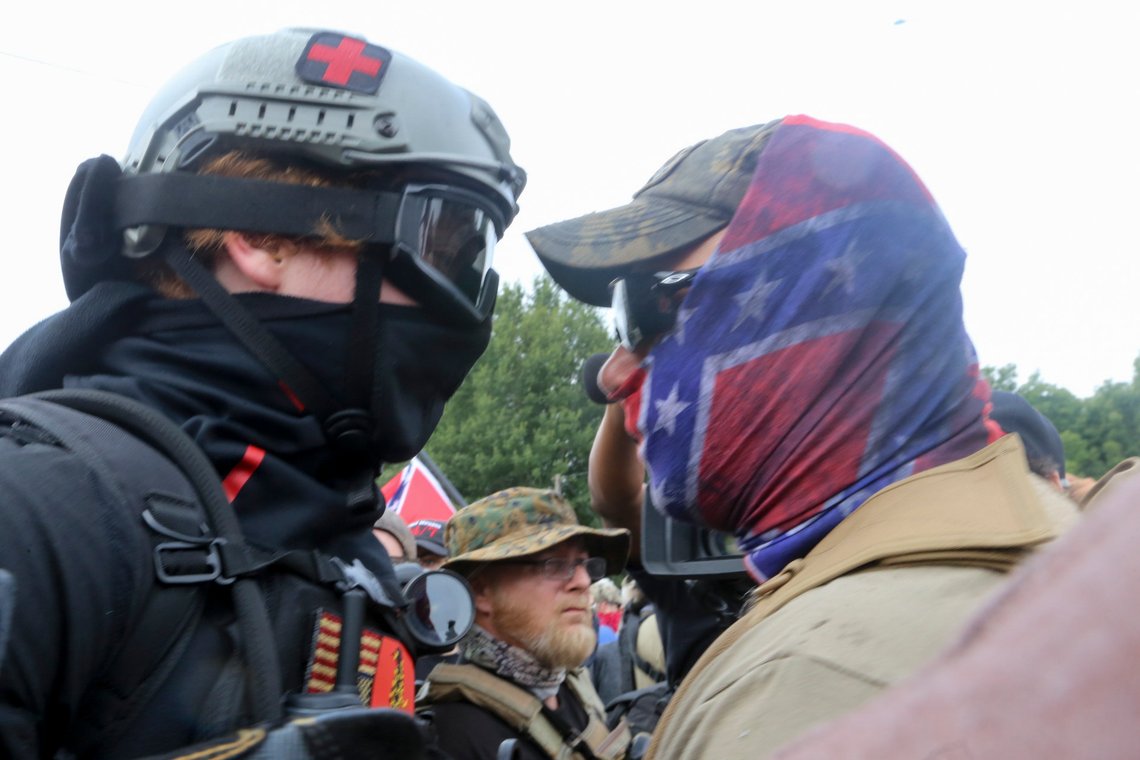 Protestors and counter protestors face off Saturday, Aug. 15, 2020, in Stone Mountain Village, Ga. Several dozen people waving Confederate flags, many of them wearing military gear, gathered in downtown Stone Mountain where they faced off against a few hundred counterprotesters, many of whom wore shirts or carried signs expressing support for the Black Lives Matter movement. (Jenni Girtman/Atlanta Journal-Constitution via AP) Protestors and counter protestors face off Saturday, Aug. 15, 2020, in Stone Mountain Village, Ga. Several dozen people waving Confederate flags, many of them wearing military gear, gathered in downtown Stone Mountain where they faced off against a few hundred counterprotesters, many of whom wore shirts or carried signs expressing support for the Black Lives Matter movement. (Jenni Girtman/Atlanta Journal-Constitution via AP)